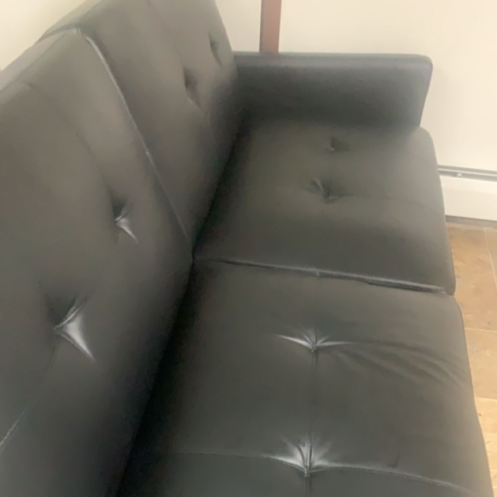 Black leather couch. Able to lay flat